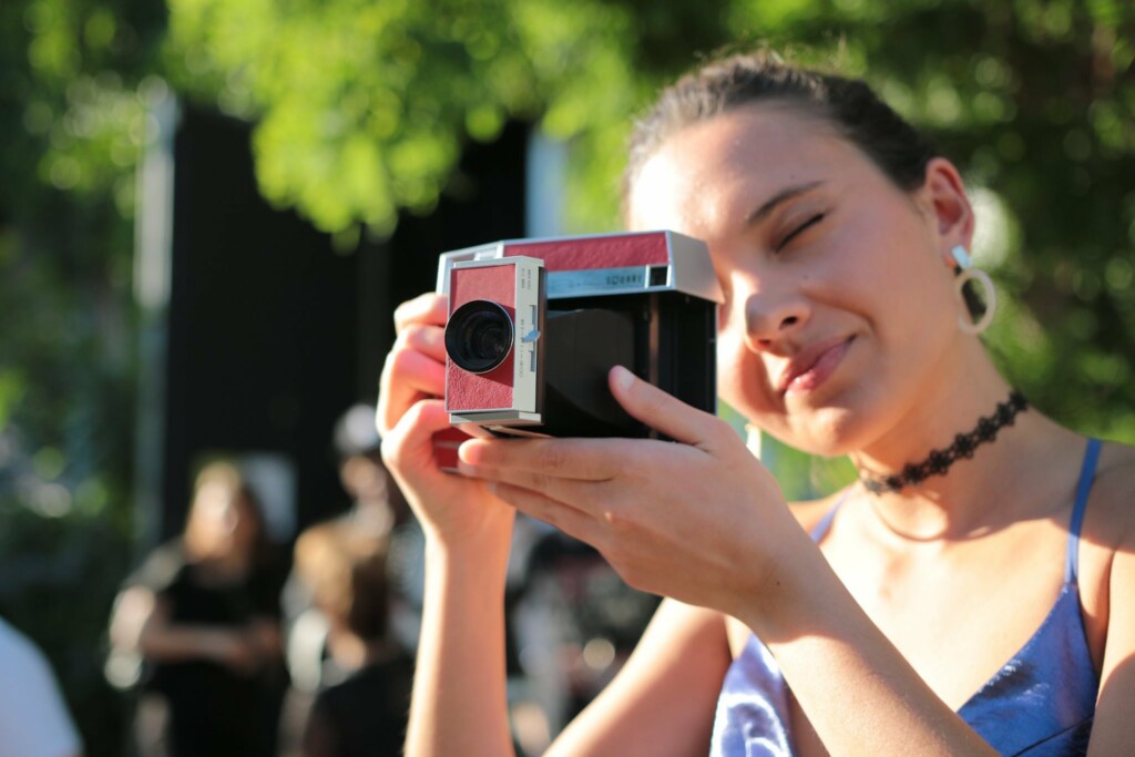 girl-taking-a-photo-outdoor-festival-bmva